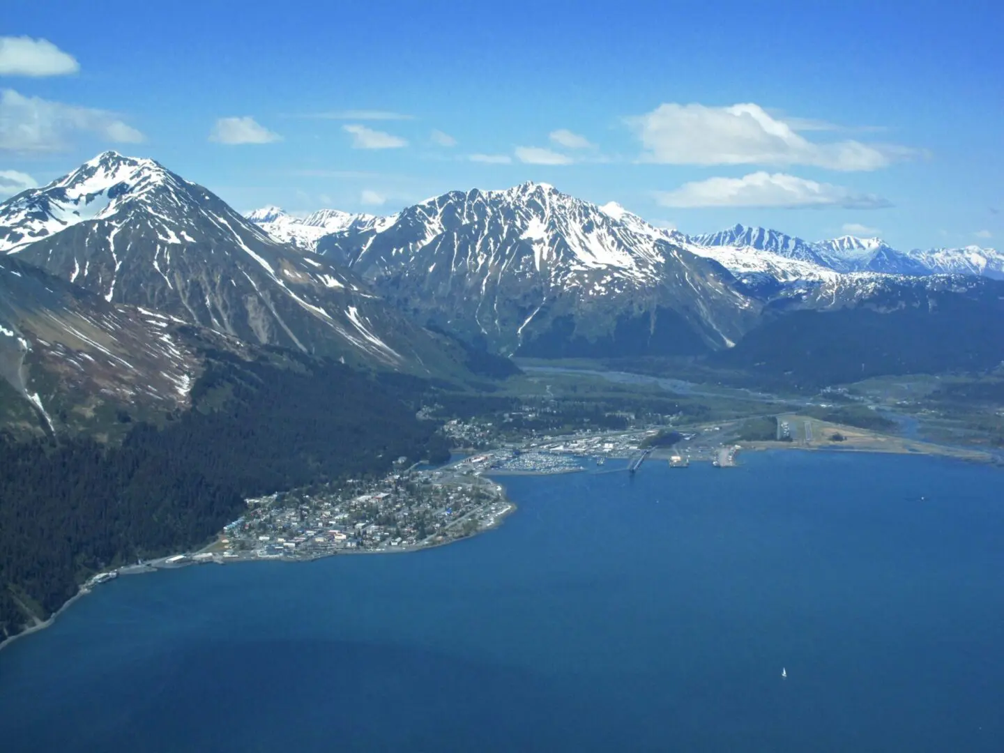 An aerial view of a mountain range and a body of water.