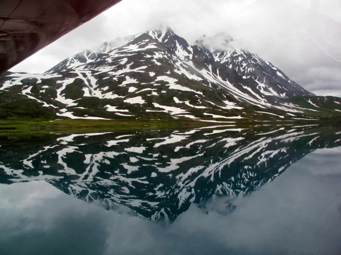 A mountain reflected in a body of water.