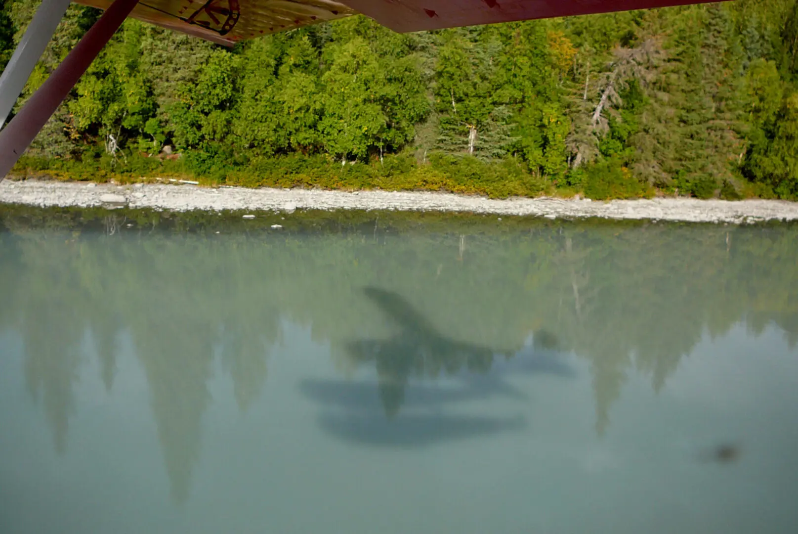 A plane is flying over a body of water.