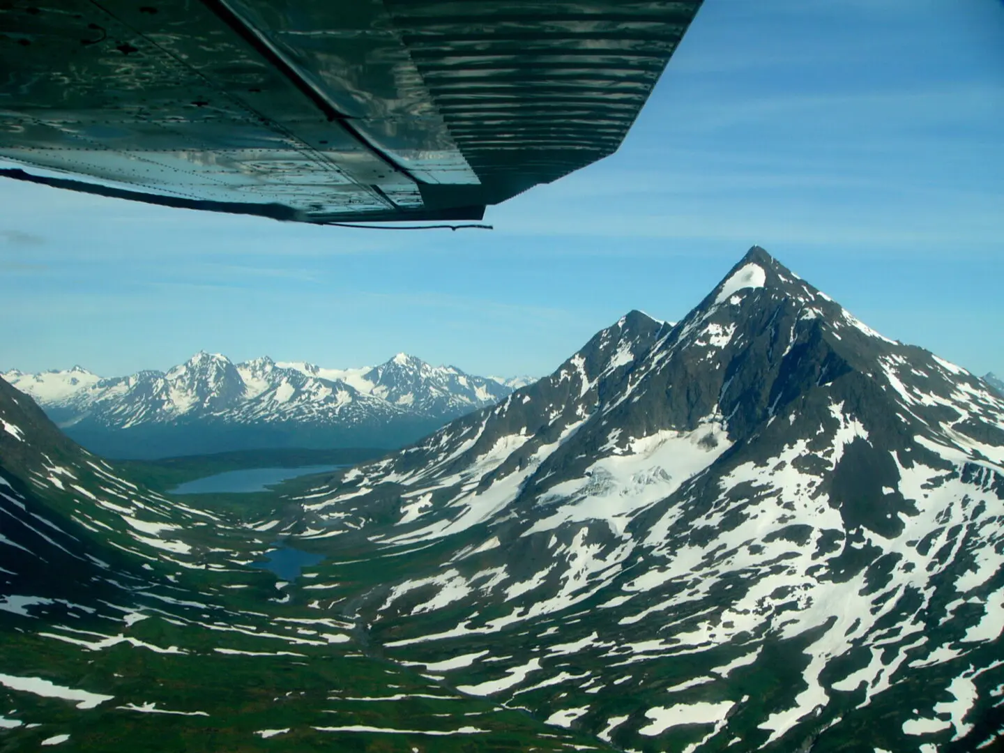 A plane flying over a mountain range.