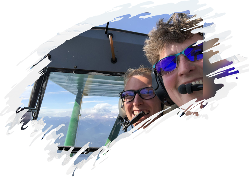 Two people in a plane looking out the window.