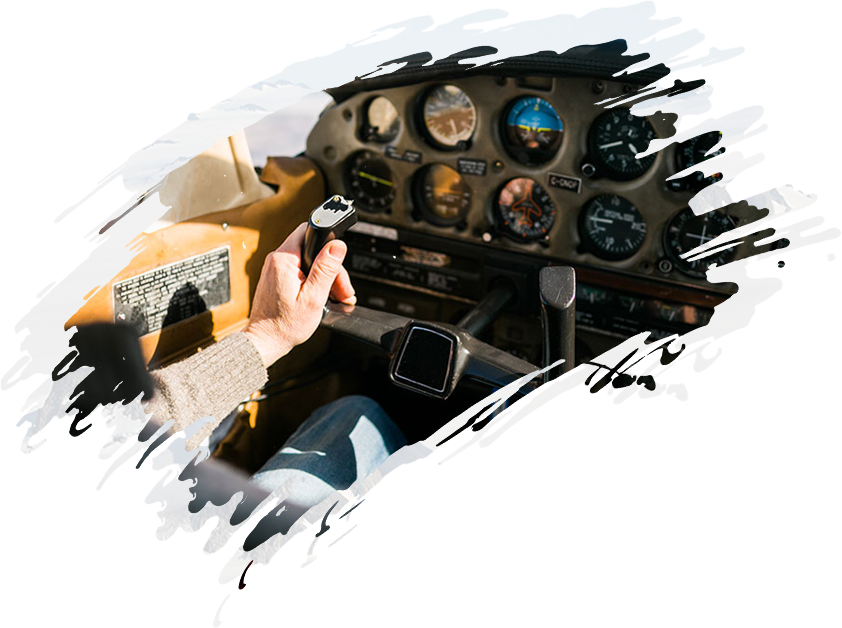 A man is sitting in the cockpit of a small airplane.