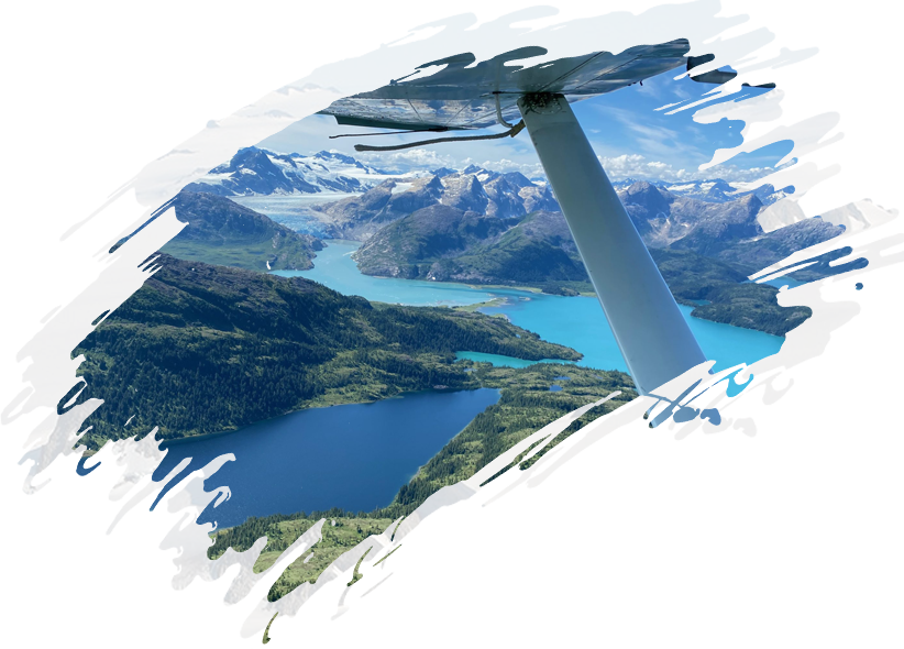 A plane flying over a lake and mountains.